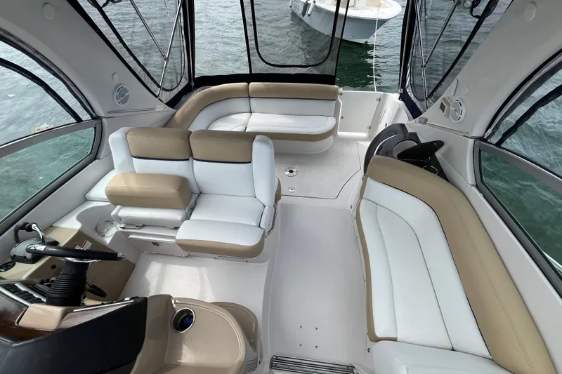 Slide: The Image of 2008 Four Winns 338 Vista boat interior with beige and white seating, docked on water. - 33