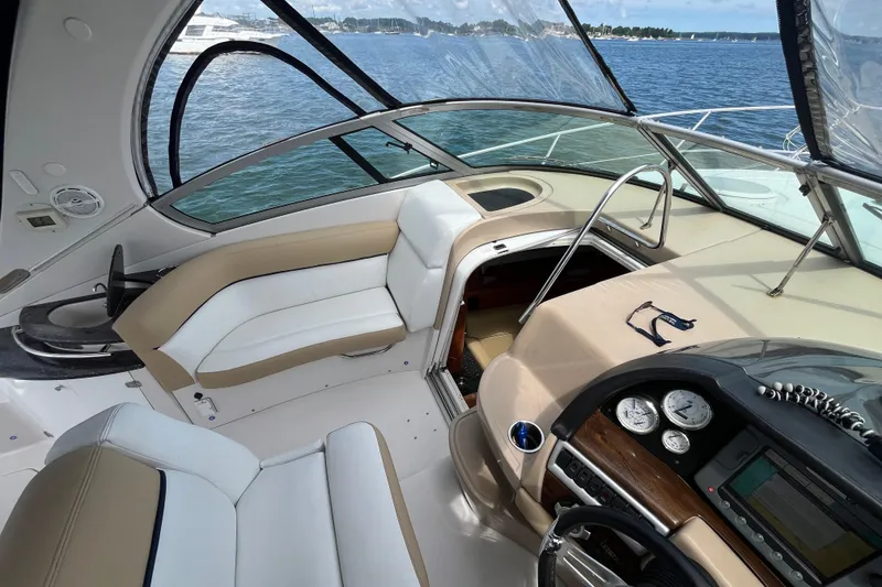 Slide: The Image of 2008 Four Winns 338 Vista boat interior with helm, seating, and open cabin hatch. - 34