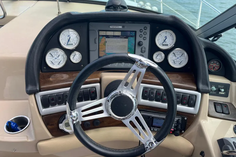 Slide: The Image of 2008 Four Winns 338 Vista boat dashboard with steering wheel and navigation instruments. - 36