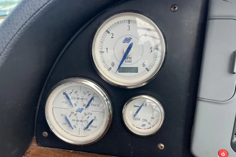 Slide: The Image of Dashboard gauges of a 2008 Four Winns 338 Vista boat, showing RPM, fuel, and trim levels. - 38