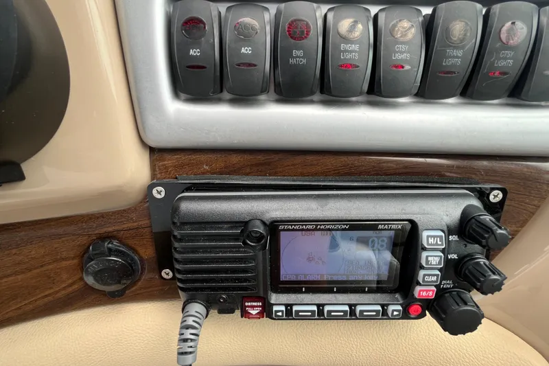 Slide: The Image of Control panel of a 2008 Four Winns 338 Vista boat with radio and switches. - 41