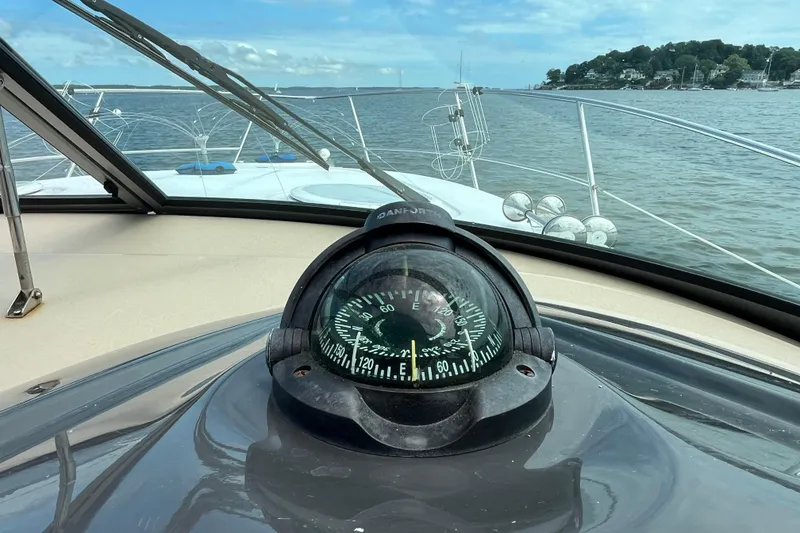 Slide: The Image of 2008 Four Winns 338 Vista boat with compass, navigating calm waters. - 43