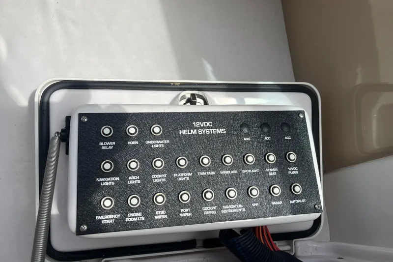 Slide: The Image of Control panel of a 2008 Four Winns 338 Vista boat, featuring various helm system switches. - 45
