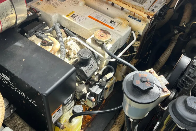 Slide: The Image of Engine compartment of a 2008 Four Winns 338 Vista boat, showing mechanical components. - 50