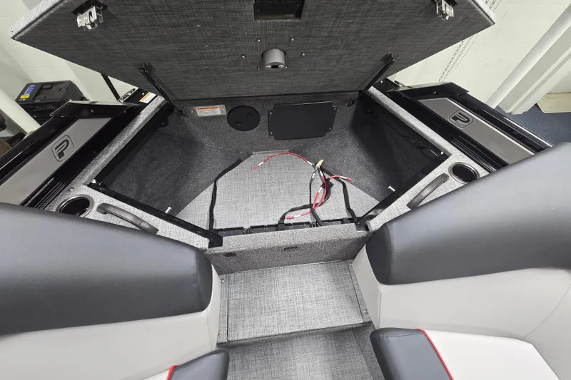 Slide: The Image of Open storage compartment in 2026 Princecraft Ventura 230 WRL boat, featuring wiring and seating. - 11