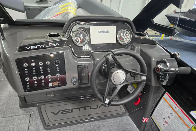 Slide: The Image of 2026 Princecraft Ventura 230 WRL boat dashboard with steering wheel and controls. - 12