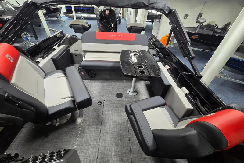 Slide: The Image of Interior of 2026 Princecraft Ventura 230 WRL boat with seating and table setup. - 14