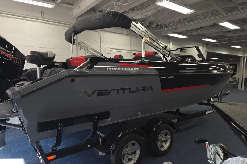 Slide: The Image of 2026 Princecraft Ventura 230 WRL boat displayed indoors on a trailer. - 16