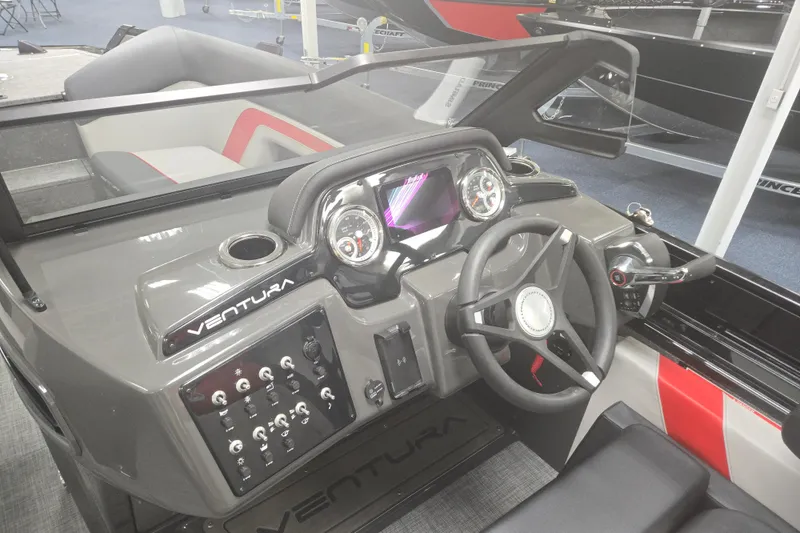 Slide: The Image of 2026 Princecraft Ventura 230 WRL boat dashboard with steering wheel and control panel. - 18