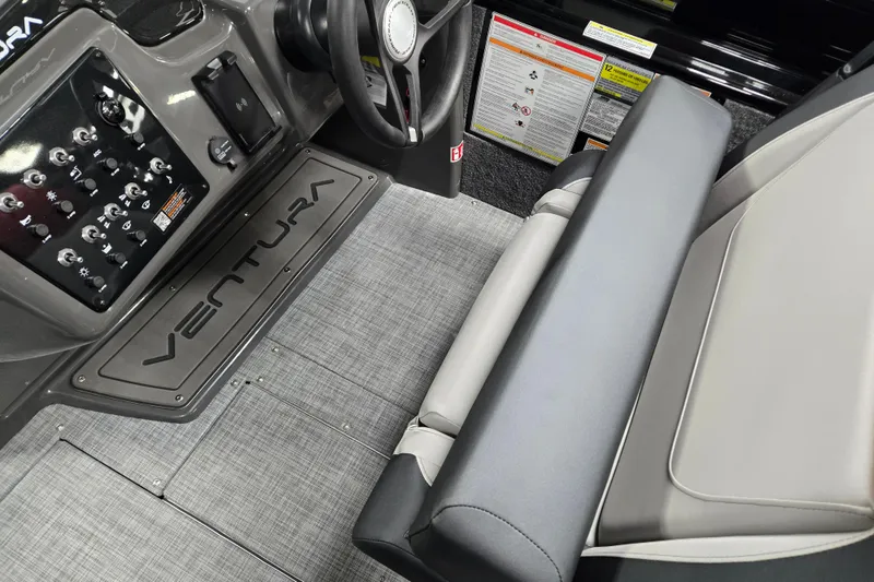 Slide: The Image of Interior of 2026 Princecraft Ventura 230 WRL boat, featuring steering wheel and control panel. - 8