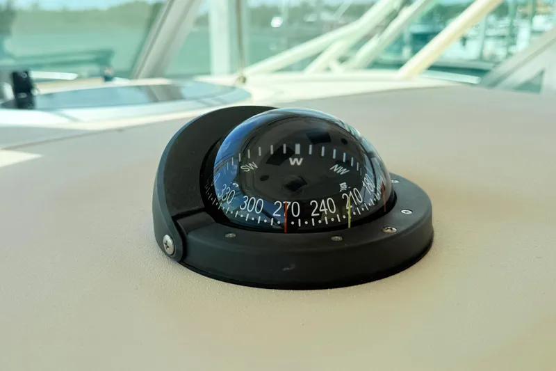 Slide: The Image of Compass on 2015 Grady-White Express 370 boat dashboard, showing navigation directions. - 12
