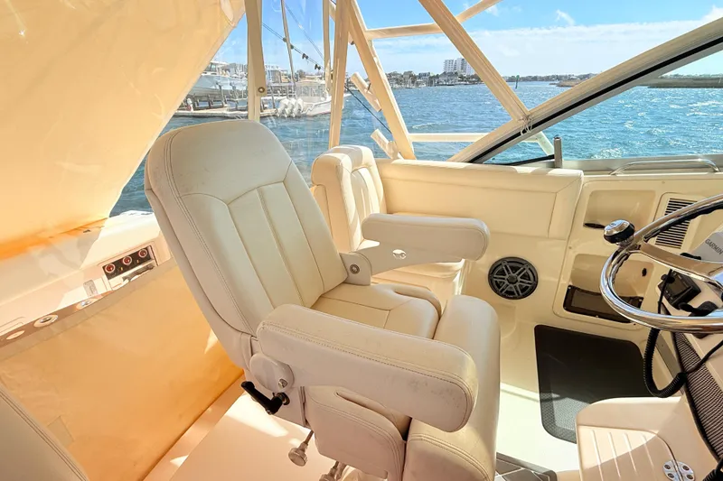 Slide: The Image of Captain's chair and helm of 2015 Grady-White Express 370 boat with ocean view. - 14