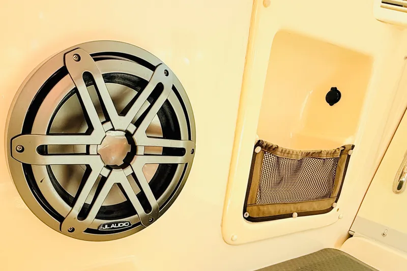 Slide: The Image of Speaker and storage compartment on 2015 Grady-White Express 370 boat interior. - 18