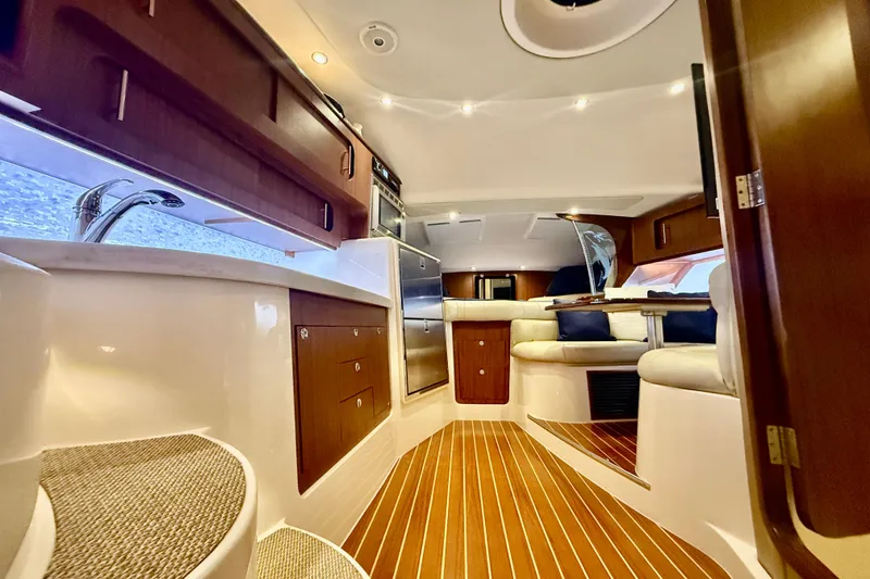 Slide: The Image of Luxurious interior of 2015 Grady-White Express 370 yacht with wood flooring and plush seating. - 19