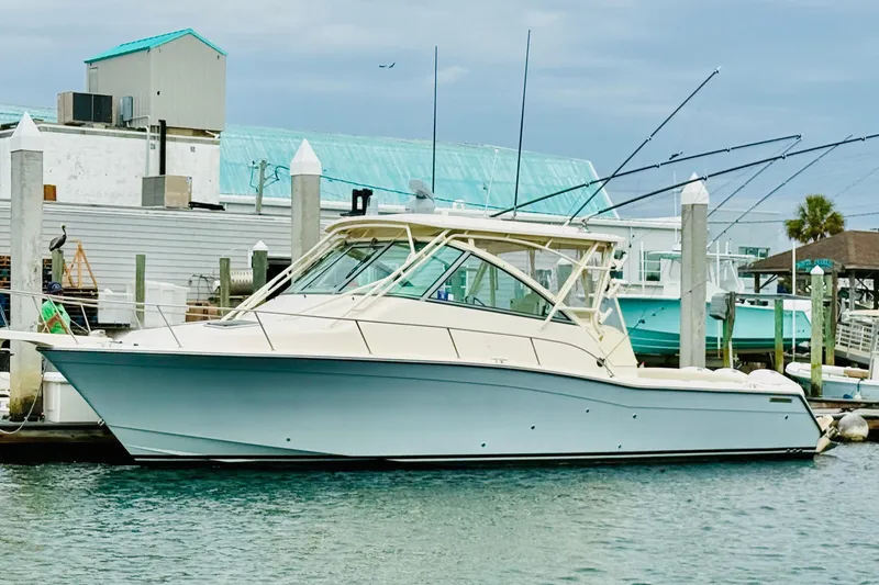 Slide: The Image of 2015 Grady-White Express 370 boat docked at marina, side view. - 2