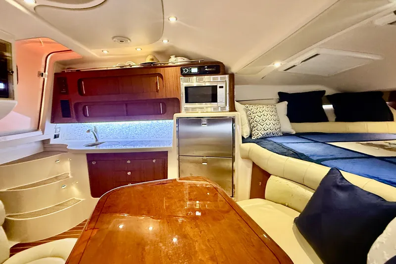 Slide: The Image of Luxurious interior of 2015 Grady-White Express 370 yacht with kitchen and cozy seating area. - 21