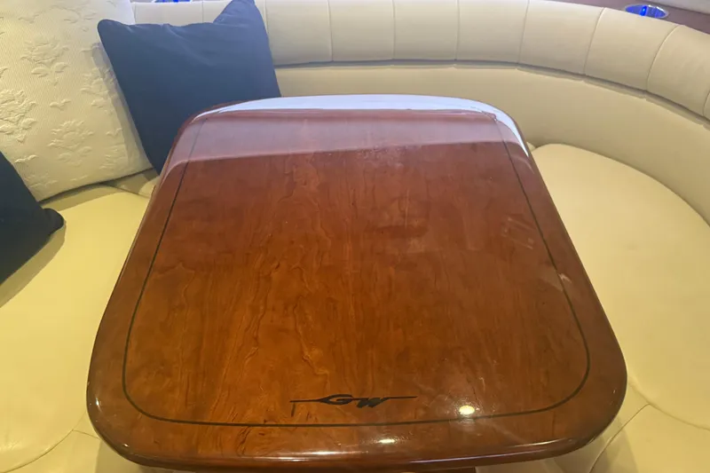 Slide: The Image of Luxurious interior of 2015 Grady-White Express 370 with polished wooden table and cushioned seating. - 25