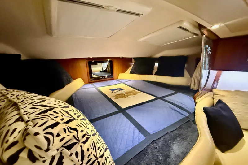 Slide: The Image of Cozy cabin interior of 2015 Grady-White Express 370 with plush bedding and pillows. - 26