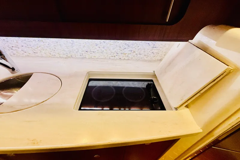 Slide: The Image of 2015 Grady-White Express 370 yacht kitchen with stove and sink. - 27