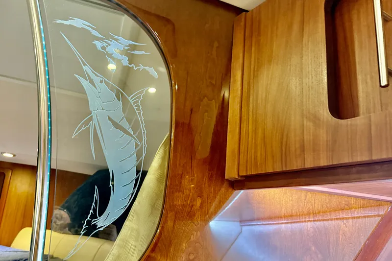 Slide: The Image of Interior of 2015 Grady-White Express 370 with etched marlin design on glass panel. - 29