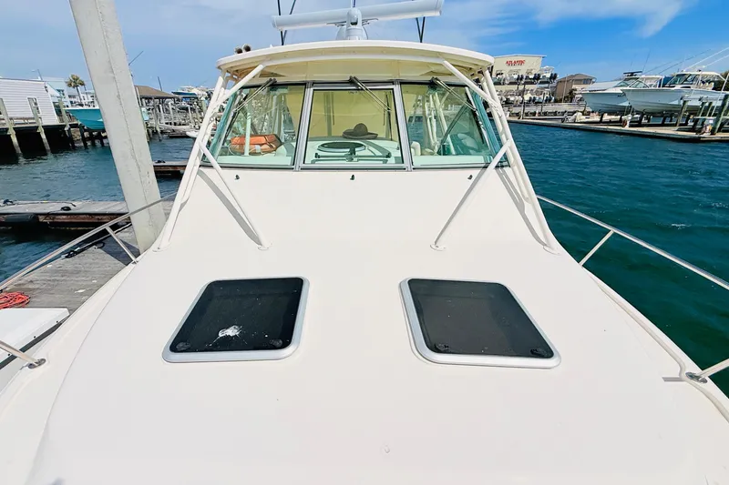 Slide: The Image of 2015 Grady-White Express 370 boat docked at marina, sunny day, clear water. - 39