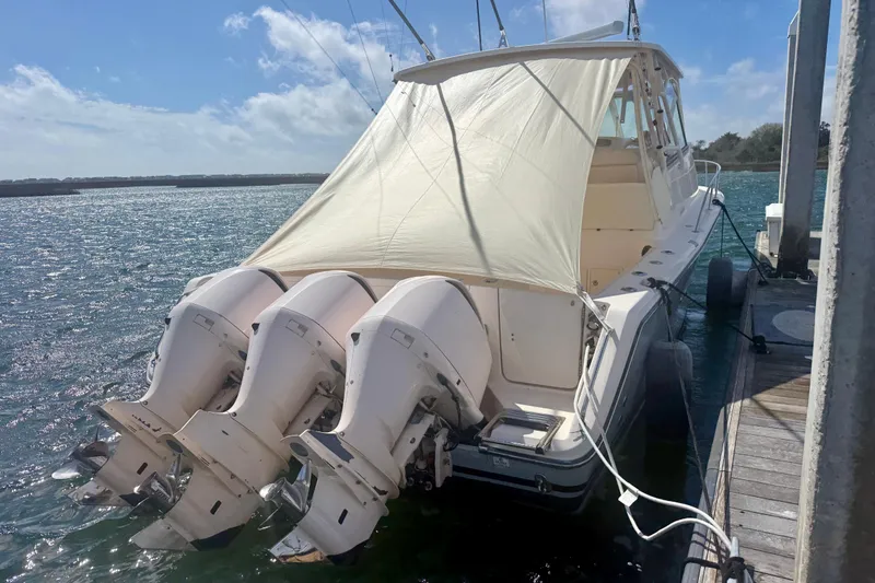 Slide: The Image of 2015 Grady-White Express 370 boat docked with triple outboard engines. - 4