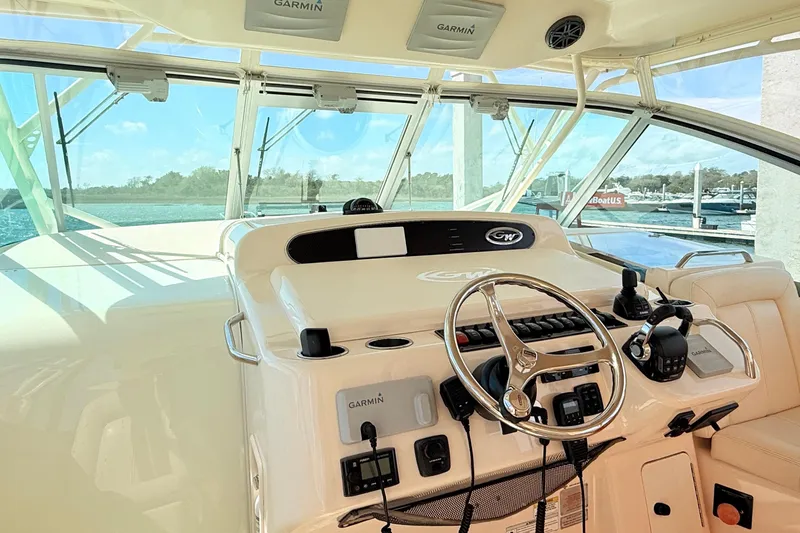Slide: The Image of 2015 Grady-White Express 370 helm with Garmin electronics, featuring a sleek steering wheel. - 7