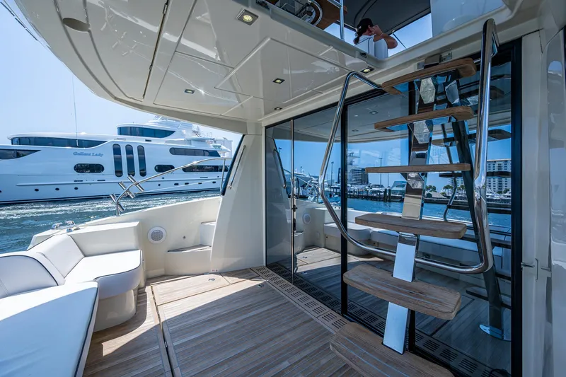Slide: The Image of 2015 Beneteau MONTE CARLO yacht interior with modern staircase and seating area. - 20