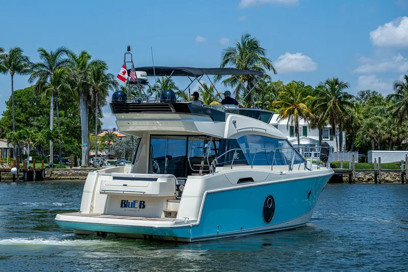 Slide: The Image of 2015 Beneteau MONTE CARLO yacht cruising on a sunny day with palm trees in the background. - 3