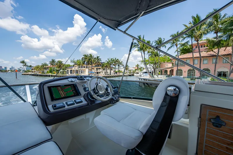 Slide: The Image of Helm of 2015 Beneteau Monte Carlo yacht with waterfront view and palm trees. - 30
