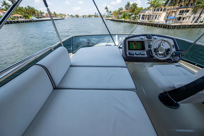 Slide: The Image of 2015 Beneteau Monte Carlo yacht helm with plush seating and scenic waterway view. - 31