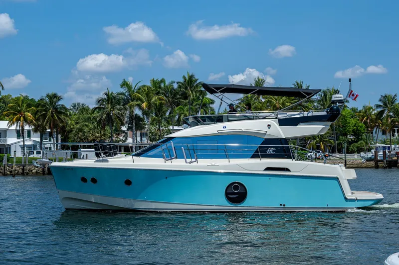 Slide: The Image of 2015 Beneteau Monte Carlo yacht cruising on a sunny day with palm trees in the background. - 4