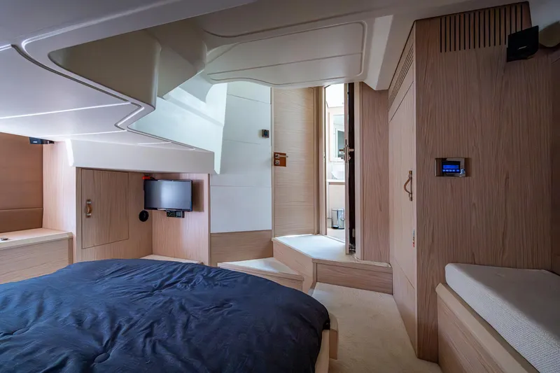 Slide: The Image of Luxurious interior of 2015 Beneteau Monte Carlo yacht with modern wood finish and cozy bedding. - 42