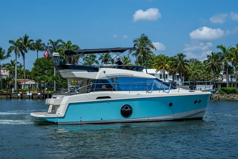 Slide: The Image of 2015 Beneteau Monte Carlo yacht cruising on a sunny day with palm trees in the background. - 6