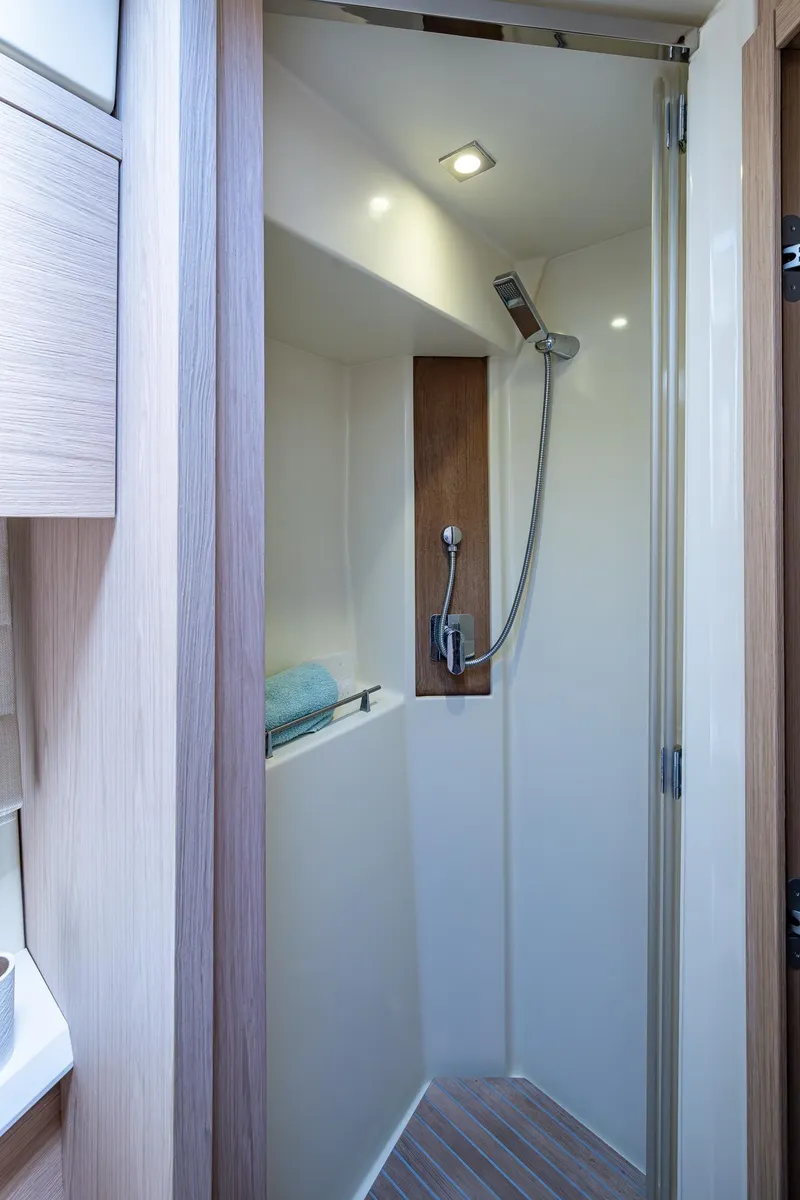 Slide: The Image of 2015 Beneteau MONTE CARLO yacht shower with modern fixtures and wooden accents. - 8