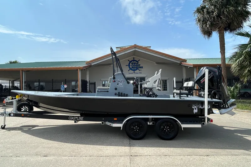 The Image of 2026 Skuta 24 Vista boat on trailer, parked outside a marine dealership. - 0