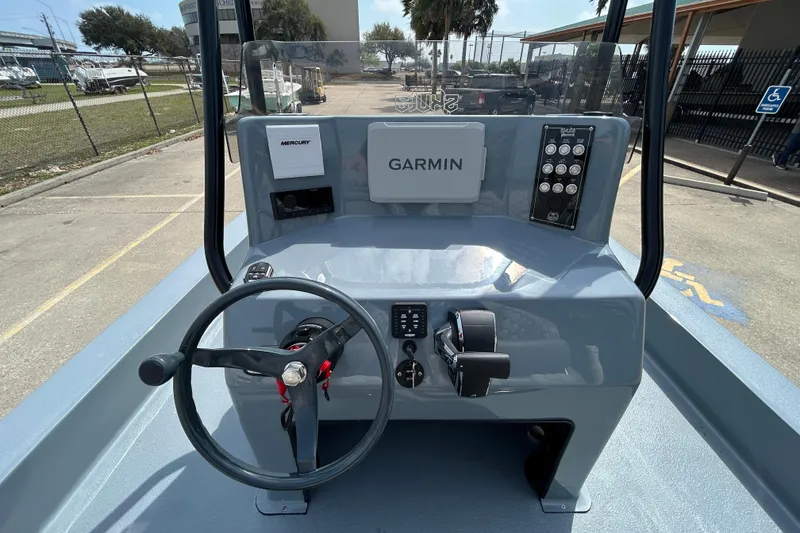 Slide: The Image of 2026 Skuta 24 Vista boat dashboard with Garmin and Mercury controls. - 11