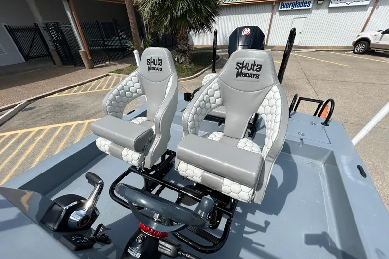 Slide: The Image of 2026 Skuta 24 Vista boat interior with stylish gray seats and steering controls. - 12