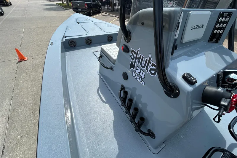 Slide: The Image of 2026 Skuta 24 Vista boat with Garmin navigation, docked on a sunny day. - 13