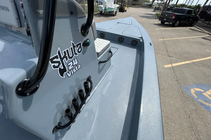Slide: The Image of 2026 Skuta 24 Vista boat, sleek design, gray finish, docked in parking lot. - 14