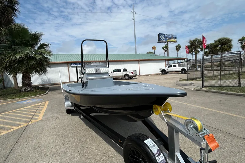 Slide: The Image of 2026 Skuta 24 Vista boat on trailer in parking lot, palm trees in background. - 3