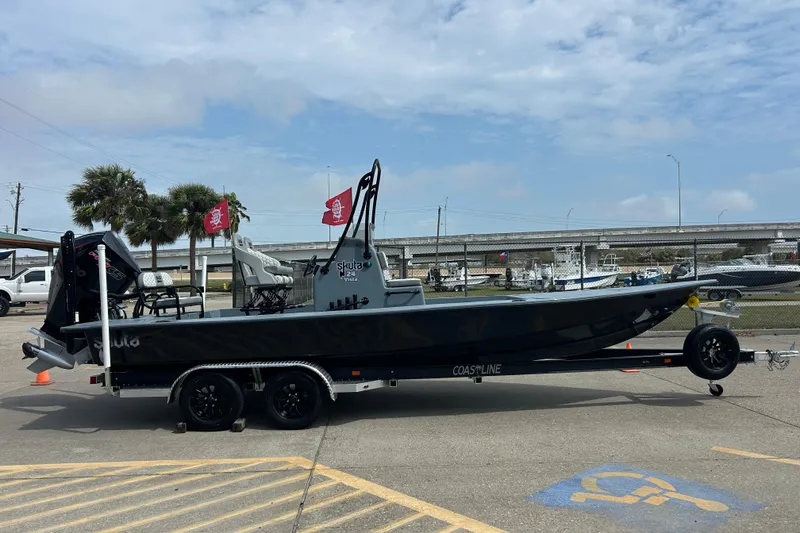 Slide: The Image of 2026 Skuta 24 Vista boat on trailer, parked outdoors under cloudy sky. - 4