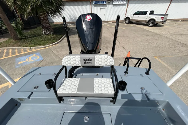Slide: The Image of 2026 Skuta 24 Vista boat with seating and motor in a parking lot. - 8