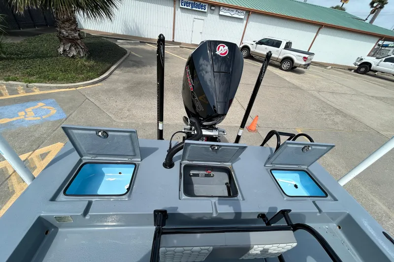 Slide: The Image of Skuta 24 Vista 2026 boat with open storage compartments and powerful outboard motor. - 9