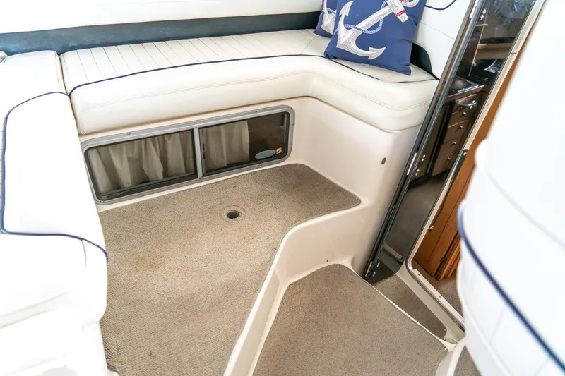 Slide: The Image of Interior of 1998 Bayliner 3255 Avanti boat with cushioned seating and nautical decor. - 10