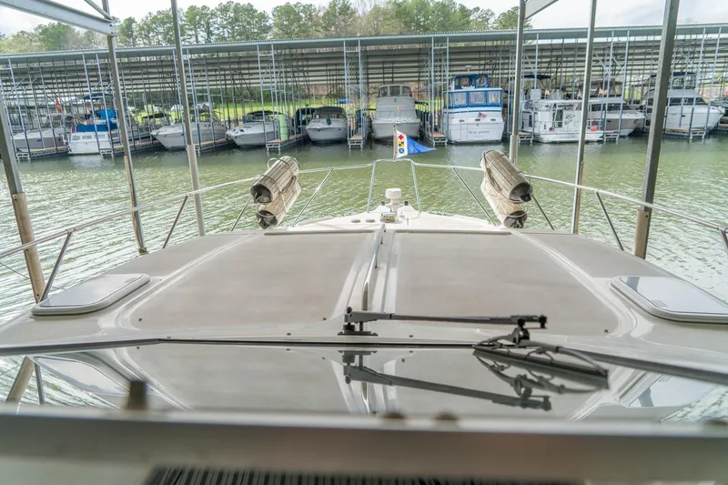 Slide: The Image of 1998 Bayliner 3255 Avanti docked in a marina with multiple boats. - 11