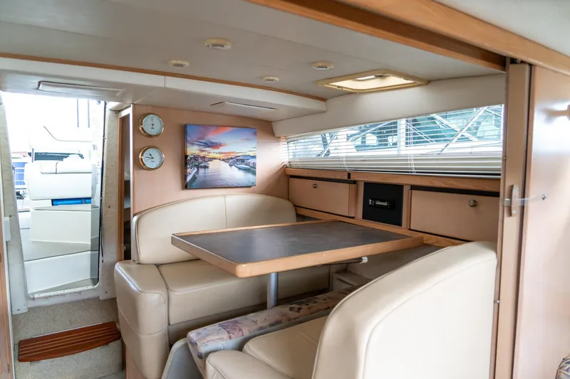 Slide: The Image of Interior of 1998 Bayliner 3255 Avanti yacht with cozy dining area and modern decor. - 15