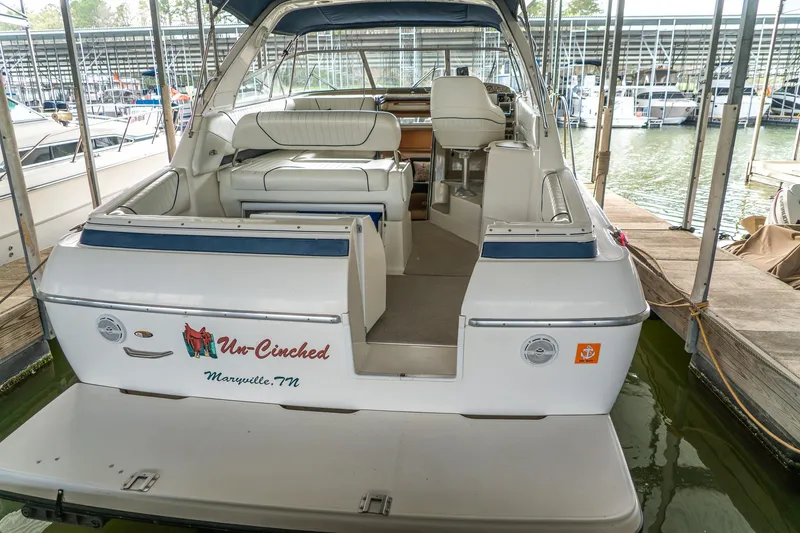 Slide: The Image of 1998 Bayliner 3255 Avanti boat docked, featuring spacious seating and sleek design. - 3