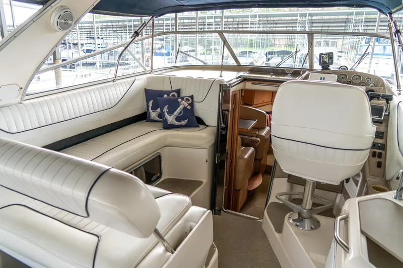 Slide: The Image of Interior of 1998 Bayliner 3255 Avanti boat with white seating and nautical decor. - 5