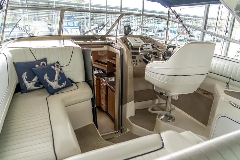 Slide: The Image of 1998 Bayliner 3255 Avanti boat interior with helm, seating, and nautical decor. - 6